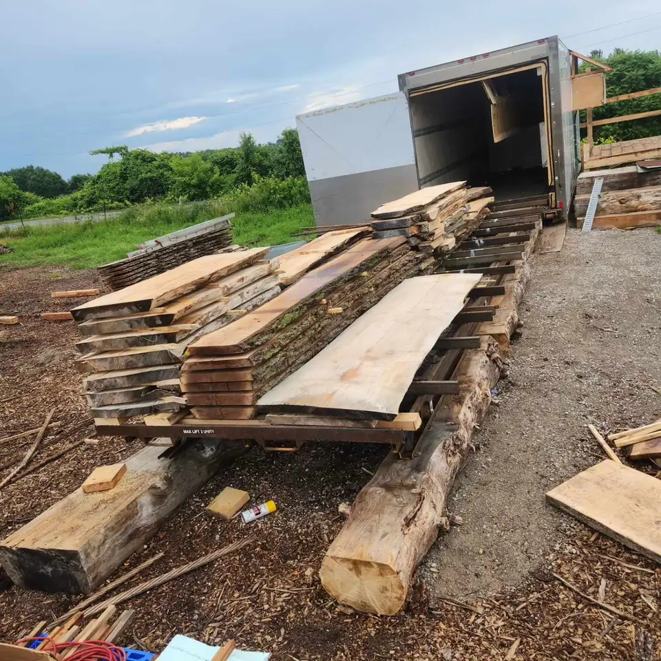 Freshly milled slabs stacked beside the kiln