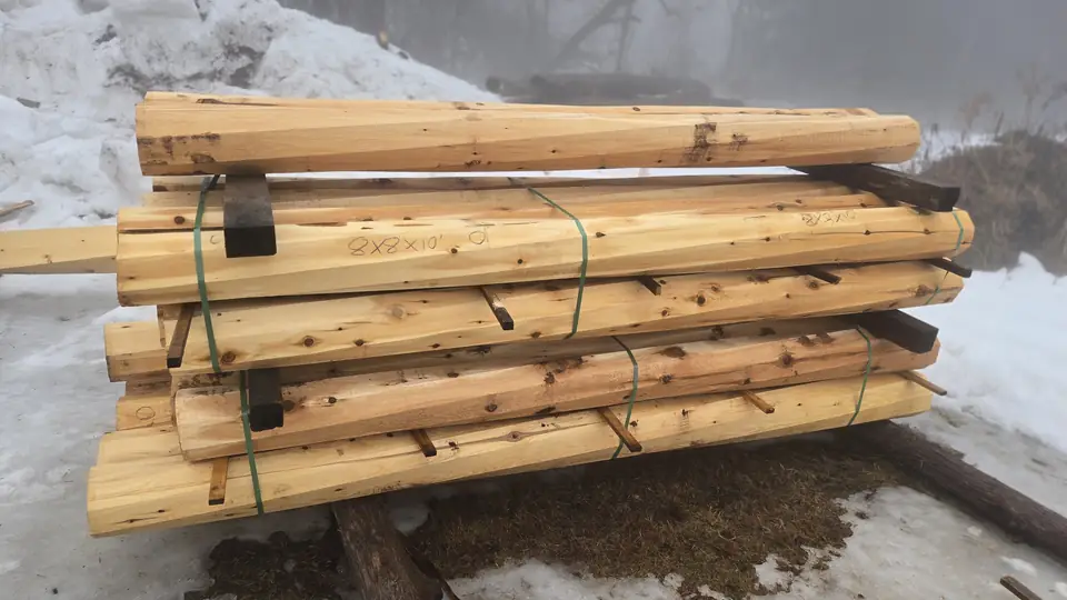 Bundles of twisted cedar timber posts strapped and ready for pickup